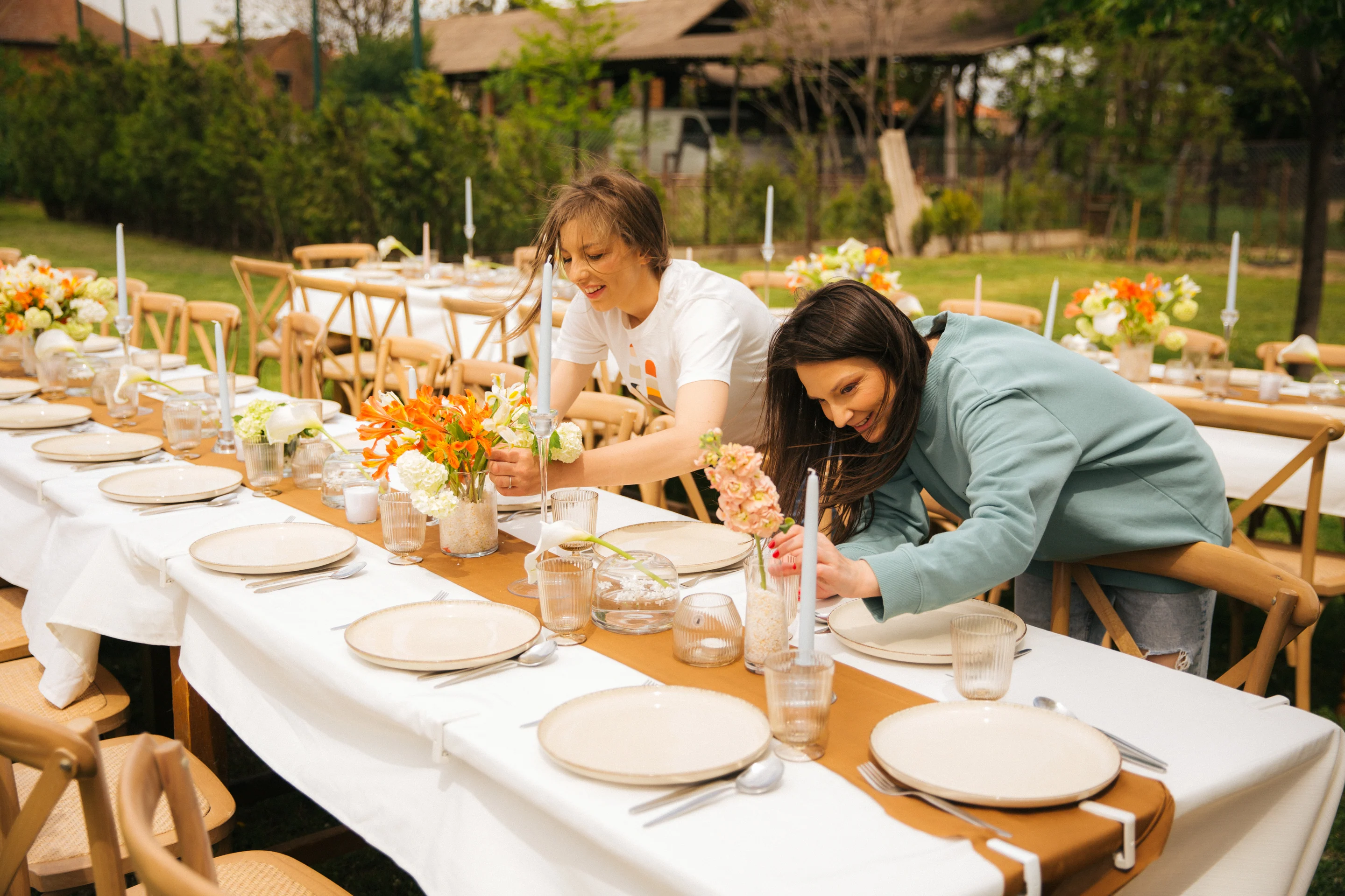 Katarina and Marija arranging flowers at a wedding table