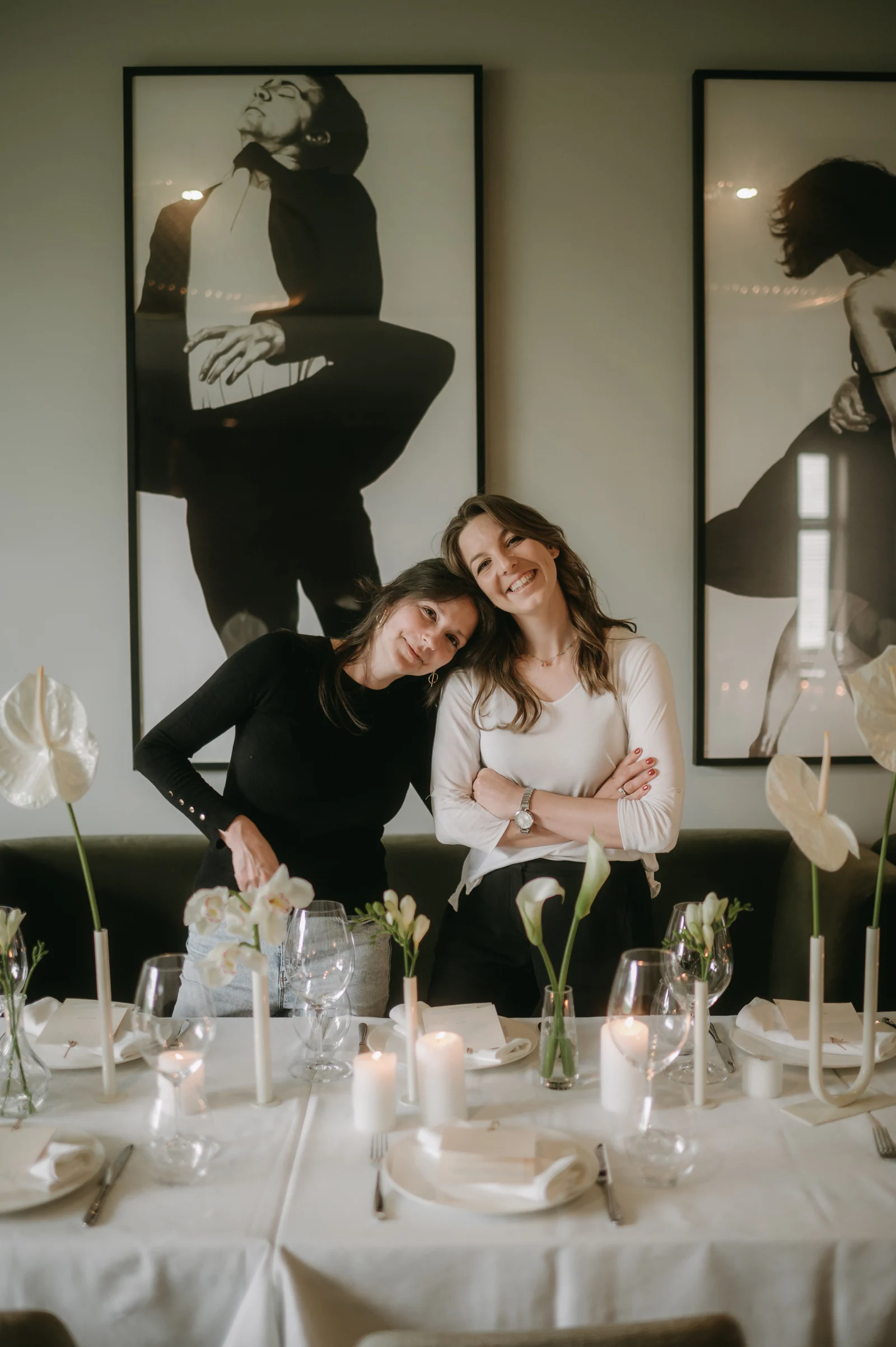 Katarina and Marija standing together at a styled dinner
