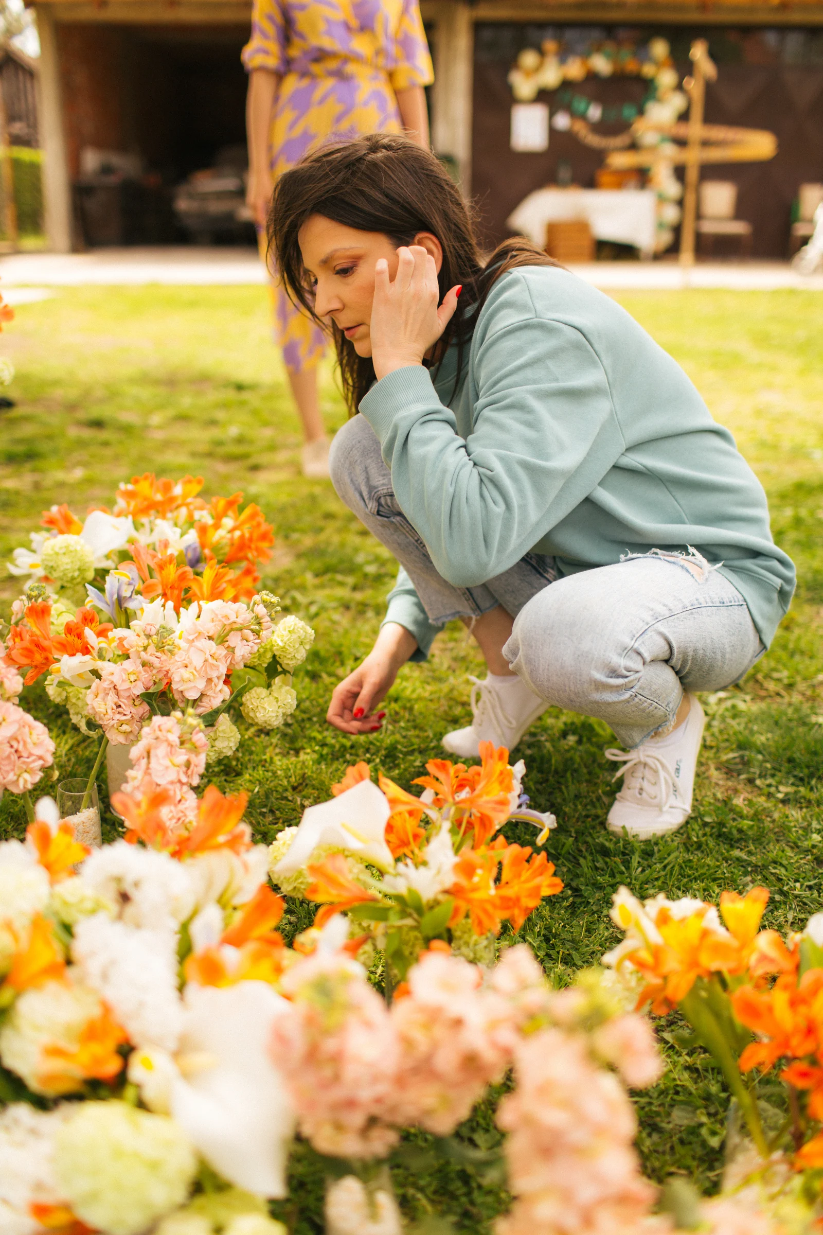 Marija arranging flowers outdoors