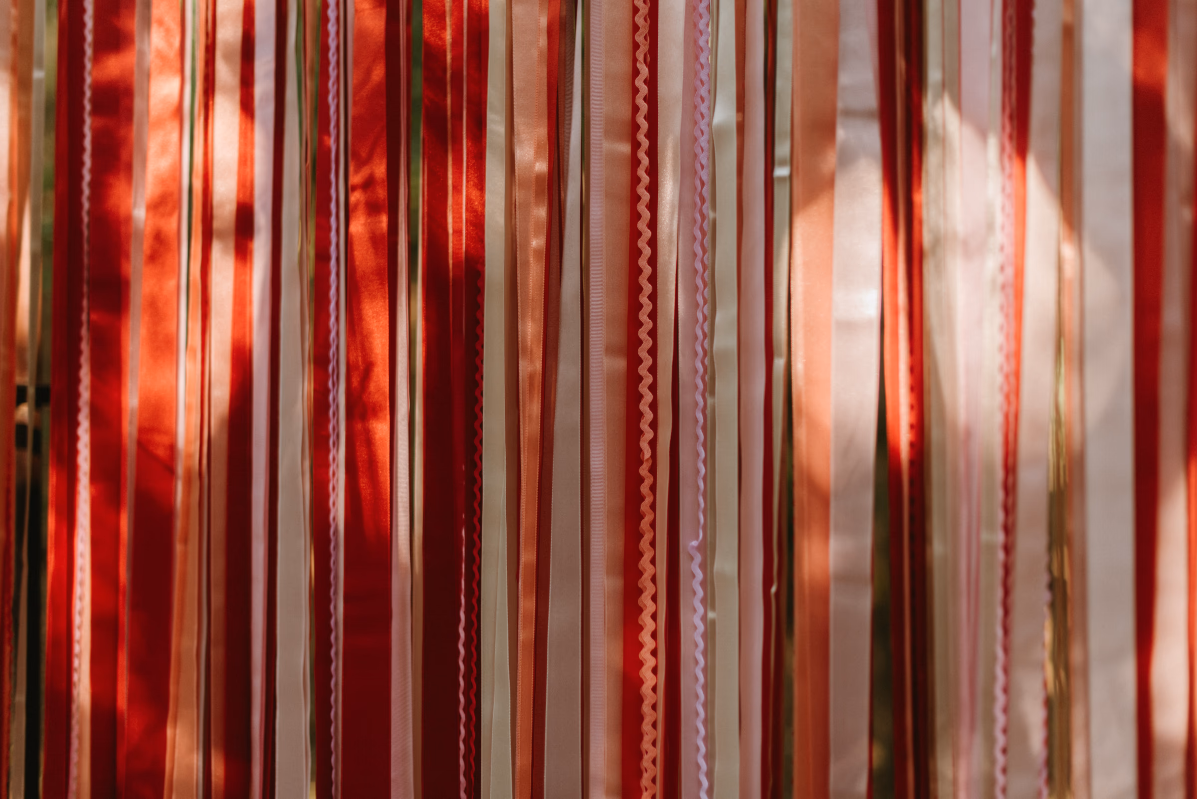 Handwritten place cards tied to flowing ribbons
